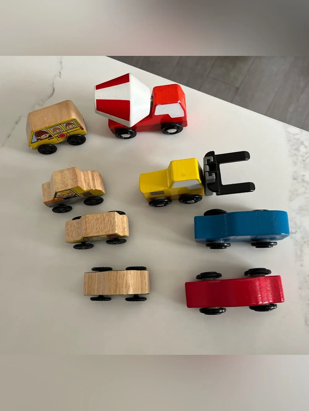8 wooden cars and trucks.  Four are kidKraft.